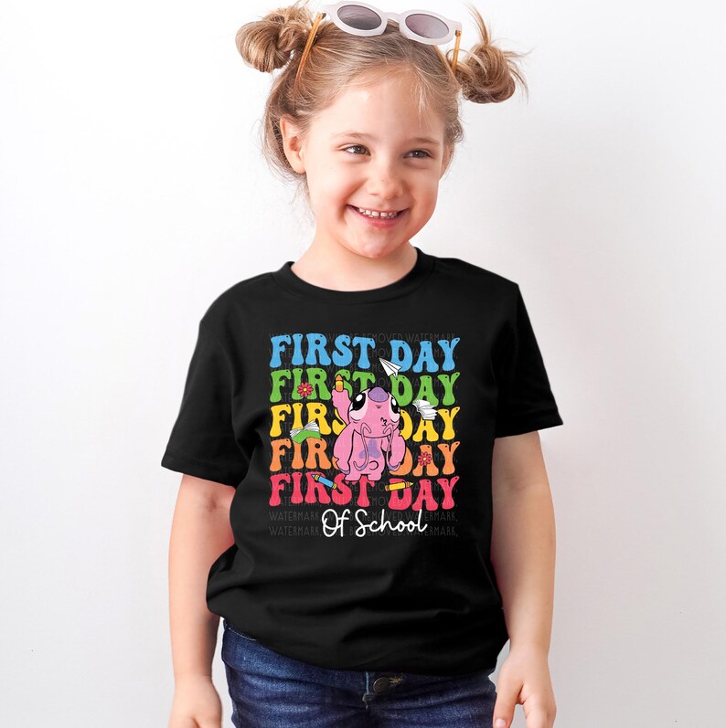 a little girl wearing a t - shirt that says first day first day first day