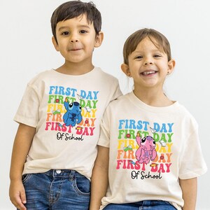 a couple of kids standing next to each other