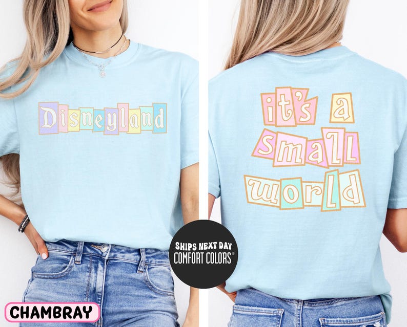 A woman wearing a light blue t-shirt with the text "Disneyland it's a small world" printed on it.