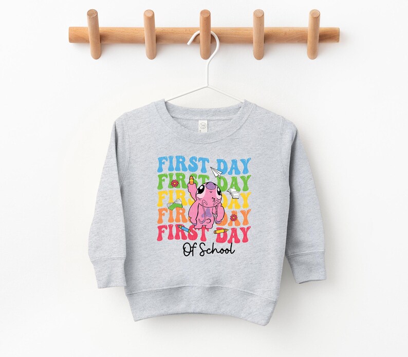 a gray sweatshirt hanging on a wooden hanger