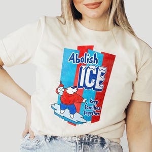 a woman wearing a t - shirt with a cartoon character on it
