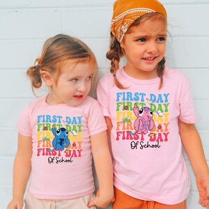 two little girls standing next to each other