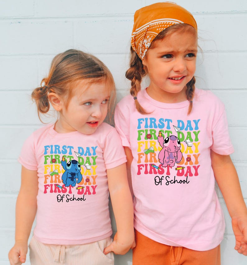 two little girls standing next to each other