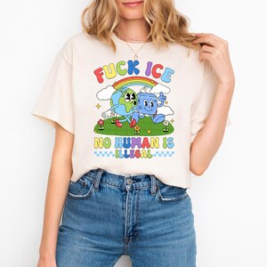 a woman wearing a t - shirt with a cartoon character on it