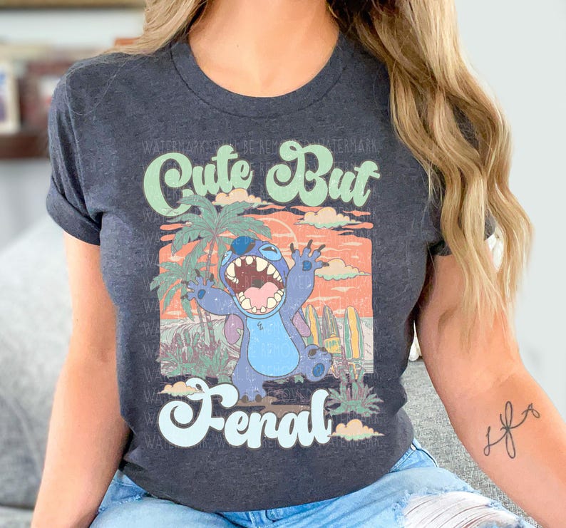a woman sitting on a couch wearing a shirt with a cartoon character on it