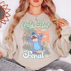 a woman wearing a sweatshirt with a cartoon character on it