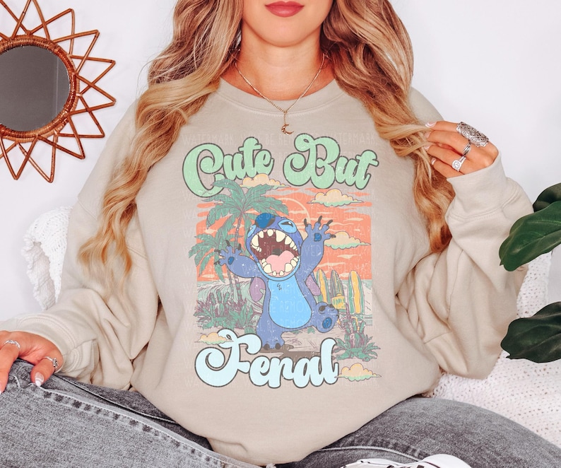 a woman wearing a sweatshirt with a cartoon character on it
