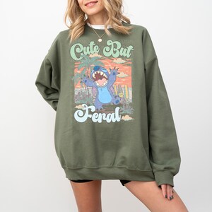 a woman wearing a sweatshirt with a cartoon character on it