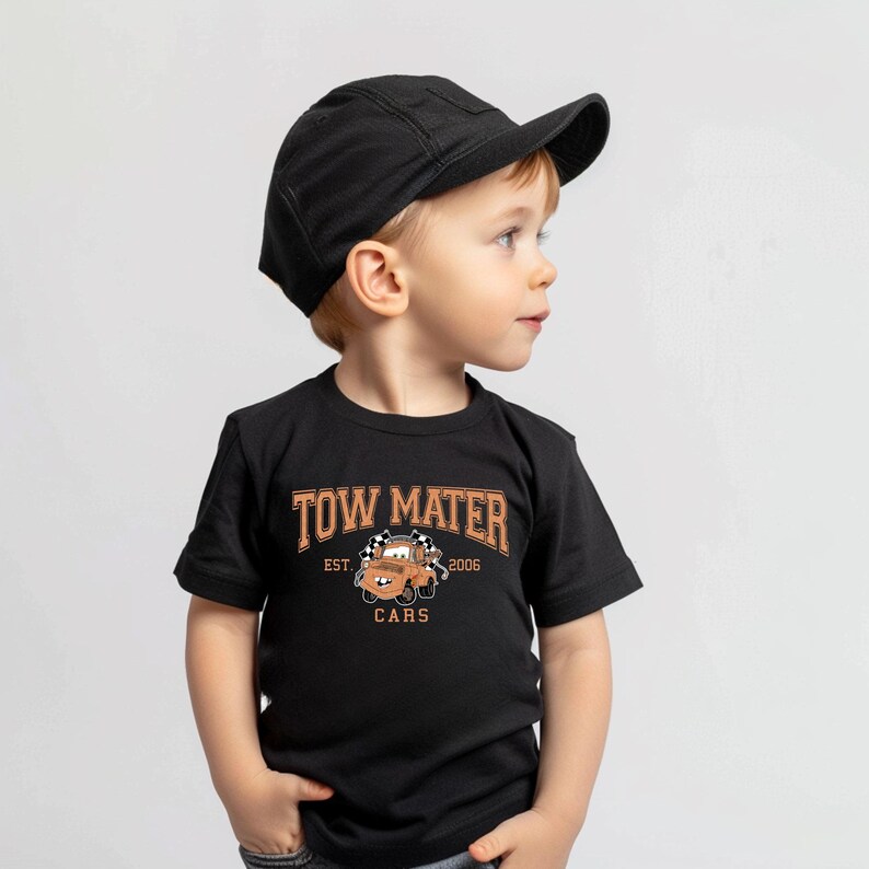 a young boy wearing a black hat and black shirt