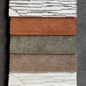 May include: A vertical display of fabric swatches in various neutral colors, including white, beige, brown, and gray. The textures vary from smooth to textured, with some featuring patterned designs. Ideal for upholstery or home decor.