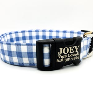 May include: Blue and white gingham dog collar with a black buckle and a personalized name tag that reads "JOEY Very Loved! 618-351-1964".