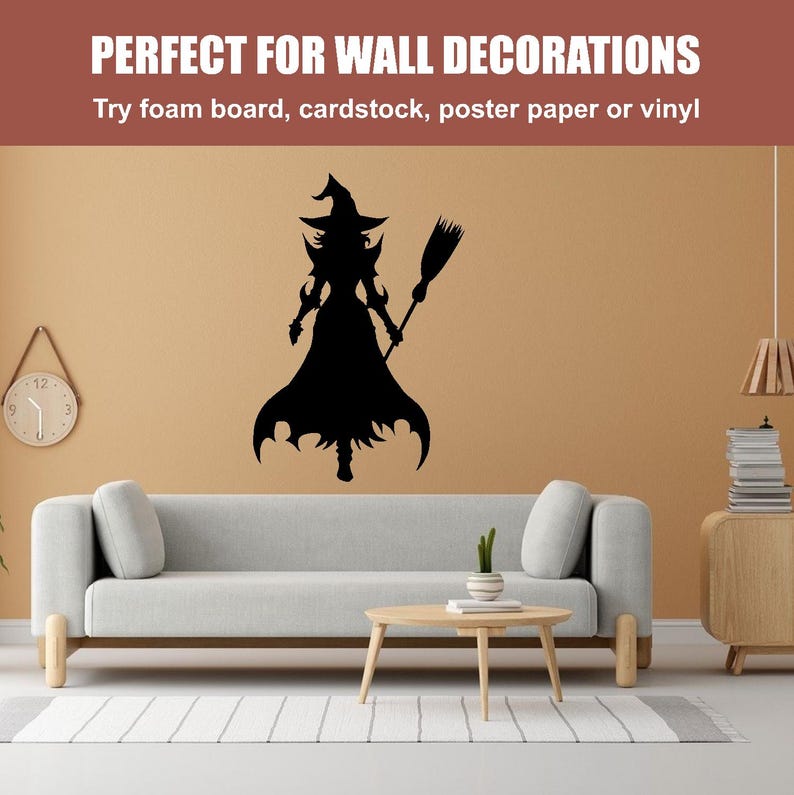 May include: Black silhouette of a witch holding a broom, on a beige wall in a living room setting. The witch is wearing a pointed hat and a long dress. There is a couch, a coffee table, and a bookshelf in the background.