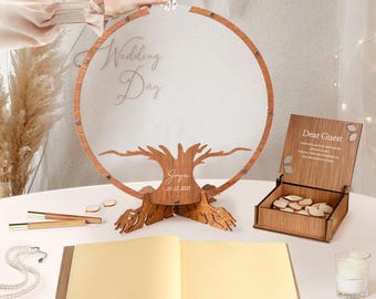 May include: A wooden wedding guest book alternative featuring a tree design with a circular frame. The words "Wedding Day" are visible. Includes a wooden box with heart-shaped tokens and a guest book. Pens and a necklace are also on the table.