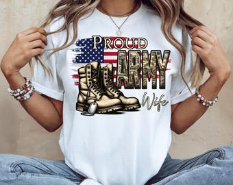 May include: White t-shirt featuring a graphic design with the text "PROUD ARMY Wife" in black and camouflage lettering. The design includes an American flag and a pair of tan military boots with a dog tag.