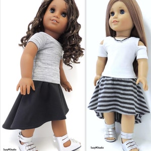 Op de afbeelding: Twee poppen die verschillende outfits dragen. De pop links draagt een grijs-wit gestreept shirt met korte mouwen en een zwarte rok. De pop rechts draagt een wit shirt met korte mouwen en uitgesneden schouders en een grijs-zwart gestreepte rok.