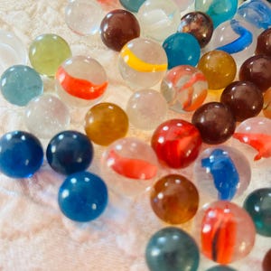 Random Collection of 1950&#39;s Marbles in a Brown Drawstring Bag