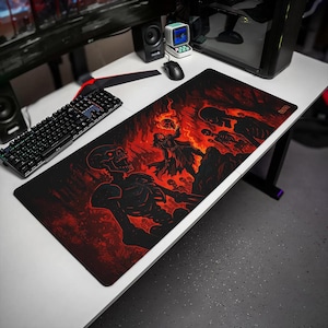May include: A rectangular desk mat featuring a dark fantasy illustration with a black and red color scheme. The graphic depicts a central figure holding a flaming skull surrounded by skeletal figures and fiery, hellish landscapes across the surface.
