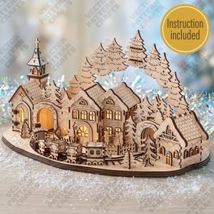 May include: A laser-cut wooden Christmas village display featuring a church with a steeple, multiple houses, and a train on tracks. The structure is illuminated from within, surrounded by wooden pine trees, and includes the text Instruction included.