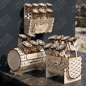 May include: Three wooden flower boxes with laser-cut floral designs. One box is rectangular with a lattice pattern, another is drum-shaped with the word "Congratulations", and the third says "Just for You".