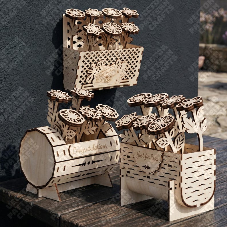 May include: Three wooden flower boxes with laser-cut floral designs. One box is rectangular with a lattice pattern, another is drum-shaped with the word "Congratulations", and the third says "Just for You".