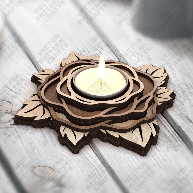 May include: A wooden candle holder in the shape of a rose, with a lit tea light candle in the center. The holder is made of layered wood, with a dark brown outer layer and lighter brown inner layers. The design includes leaf details.