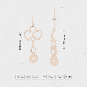 May include: Two wooden clock hands with intricate designs. The hour hand is 88mm long and the minute hand is 110mm long.