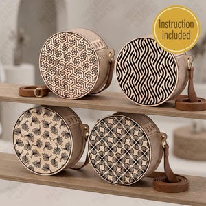 May include: Four round wooden bags with brown leather straps. Each bag features a unique black laser-cut geometric or botanical pattern on the front panel. A yellow circular badge in the top right corner contains the text Instruction included.