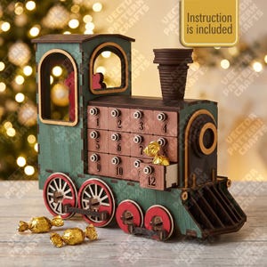 May include: A wooden train-shaped advent calendar with a teal body, dark brown roof and smokestack, and red wheels. It features twelve numbered drawers for small treats, with one drawer open showing a gold-wrapped candy. Text reads Instruction is included.