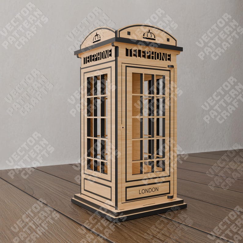 Pu&ograve; includere: Un modello in legno di una cabina telefonica rossa britannica con le parole "TELEPHONE" e "LONDON" sul davanti. Il modello &egrave; in legno e ha un bordo nero.