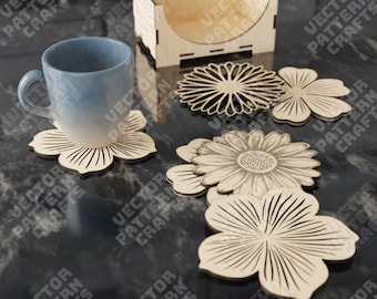 May include: A light blue mug rests on a wooden flower-shaped coaster. Several other laser-cut wooden coasters in various floral designs are displayed, along with a wooden holder. The coasters are made of light-colored wood.