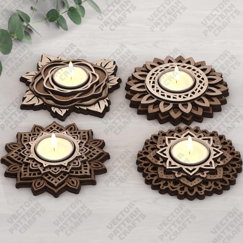 May include: Four wooden candle holders with lit candles. Each holder has a unique floral or geometric design, with a natural wood finish. The candle holders are arranged on a light-colored surface.