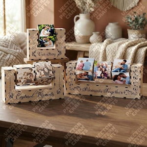 May include: Wooden photo displays with laser-cut designs. One display reads "Our Story" and holds two photos. Another says "Captured Moments" and holds multiple photos. The third display says "Moments Together" and holds multiple photos.