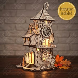 May include: A laser-cut wooden haunted clock tower model with internal warm lighting, featuring a large clock face, a ghost figure on the roof, a small open door, and a bare tree silhouette. A yellow circular badge states Instruction included.
