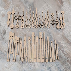 May include: A set of 30 wooden clock hands in various styles and sizes. The hands are made of unfinished wood and are ready to be painted or stained.