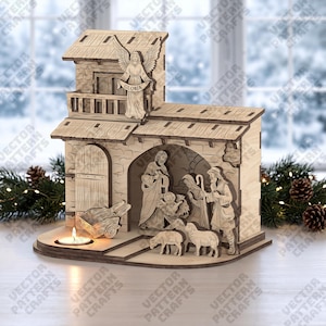 May include: A light-colored wooden nativity scene featuring a two-story structure with a balcony, an angel holding a banner that reads Gloria, and a central archway containing figures of Joseph, Mary, and the infant Jesus, with sheep and a cart.