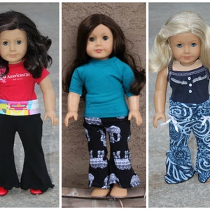 May include: Four dolls wearing different outfits. The dolls are wearing bell bottom pants, a red shirt with the text "American Girl" on it, a turquoise shirt, a black tank top with a white lace trim, and a pink shirt. The dolls are all wearing different colored shoes.