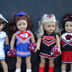 May include: Four dolls dressed in different cheerleading uniforms. The dolls are wearing white, blue, red, and black cheerleading outfits with pom-poms. The outfits have different team names, including "K", "CHEER", "STATE", and a paw print.