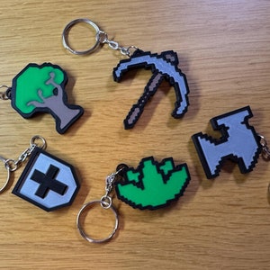3D printed Old School RuneScape skill icon keychains featuring vibrant, pixelated designs. Includes iconic skills like Mining, Herblore, and defense. Perfect for RuneScape fans to show off their love for the game as stylish and durable accessories.