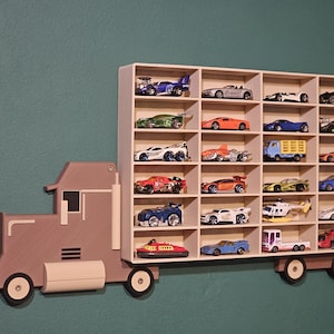 3D-printed truck-themed wall shelf with wooden finish PLA, designed for car storage. Ideal for adult and child car collectors to organise and display collectables neatly in 24 compartments. A functional decor piece that adds charm to any room.