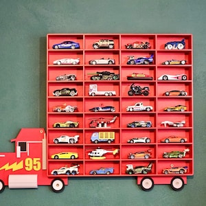 Red Disney-inspired toy car storage truck with shelving, perfect for holding Hot Wheels or Matchbox cars. This fun practical display is a great way to organise a child’s room while encouraging creativity and play. Available in customisable colours.
