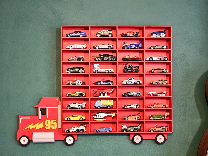 Red Disney-inspired toy car storage truck with shelving, perfect for holding Hot Wheels or Matchbox cars. This fun practical display is a great way to organise a child’s room while encouraging creativity and play. Available in customisable colours.