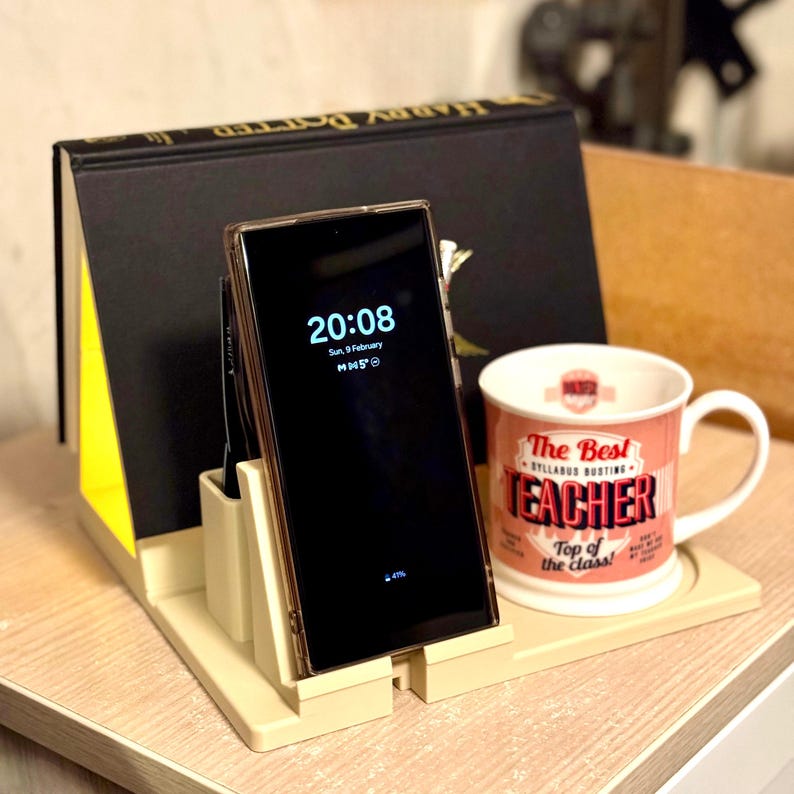 bedside organiser with book stand, phone dock, and cup holder. Multi-functional storage for nightstands, featuring an upright pen holder and LED tea light space. Ideal for keeping essentials tidy in a bedroom or office. 3D printed.