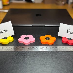 A selection of flower shaped floral place card holders, 3d printed. Perfect for weddings or restaurants that want a unique personalised event or wedding. For holding cards such as 'groom' 'bride' etc. Can also be kept as wedding favours
