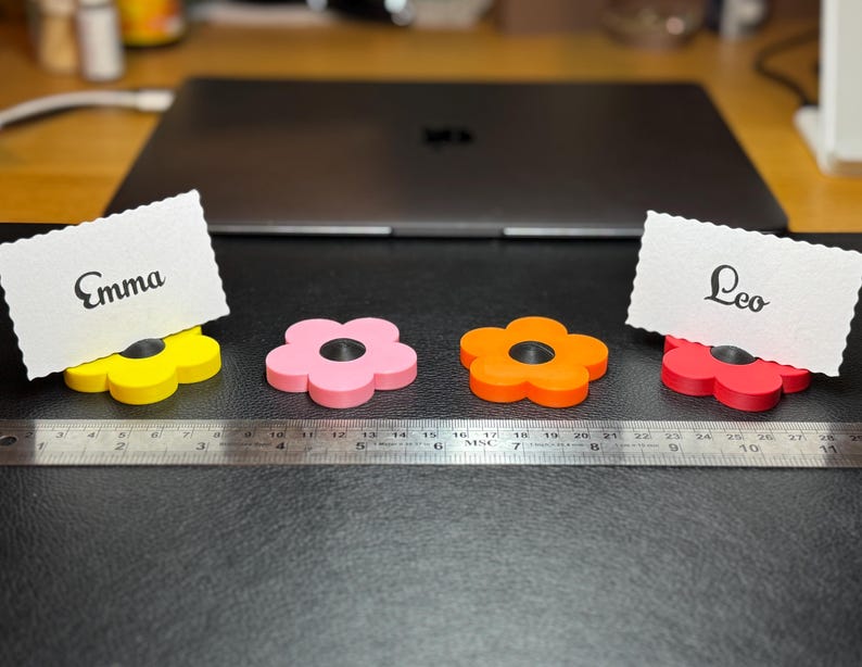 A selection of flower shaped floral place card holders, 3d printed. Perfect for weddings or restaurants that want a unique personalised event or wedding. For holding cards such as 'groom' 'bride' etc. Can also be kept as wedding favours