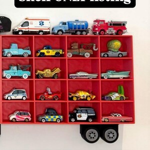 May include: A red shelf displaying a collection of toy cars, including an ambulance, water truck, and fire truck. The shelf has multiple compartments, each holding a different miniature vehicle. Text on the image reads "Shelf ONLY listing" and "Truck cab NOT included."