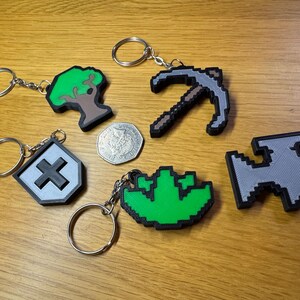 3D printed Old School RuneScape skill icon keychains featuring vibrant, pixelated designs. Includes iconic skills like Mining, Herblore, and defense. Perfect for RuneScape fans to show off their love for the game as stylish and durable accessories.