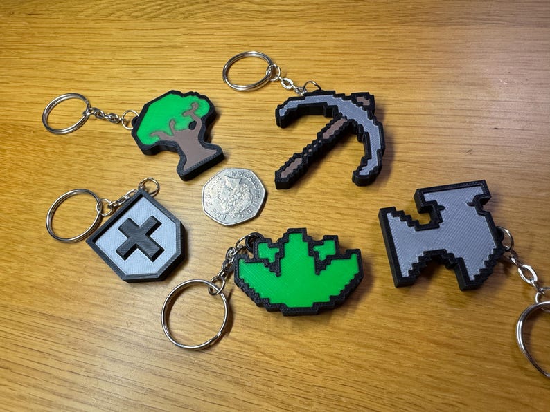3D printed Old School RuneScape skill icon keychains featuring vibrant, pixelated designs. Includes iconic skills like Mining, Herblore, and defense. Perfect for RuneScape fans to show off their love for the game as stylish and durable accessories.