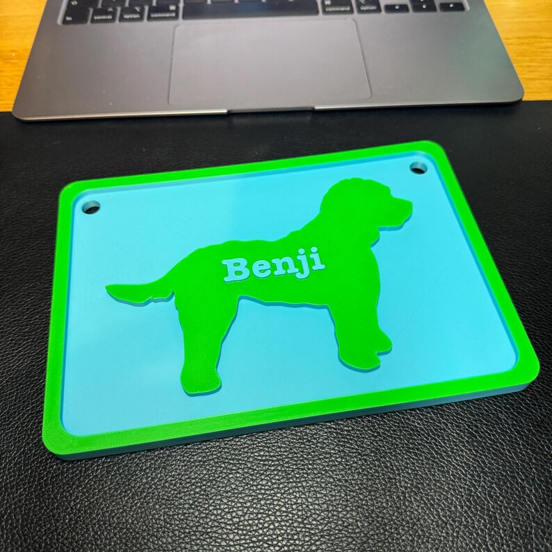 personalised 3D-printed dog name sign with a raised Cockapoo silhouette, custom name, and vibrant colour options. Ideal for dog crates, kennels, or home decor. Lightweight yet durable, with optional hanging holes. Customisable for any breed.