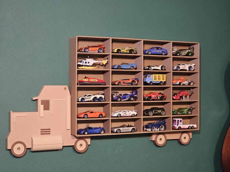 3D-printed truck-themed wall shelf with wooden finish PLA, designed for car storage. Ideal for adult and child car collectors to organise and display collectables neatly in 24 compartments. A functional decor piece that adds charm to any room.