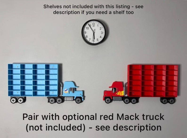 May include: Two toy semi-trucks, one blue and one red, each with a shelf-like trailer. A black clock hangs above them. The text reads "Pair with optional red Mack truck (not included) - see description."